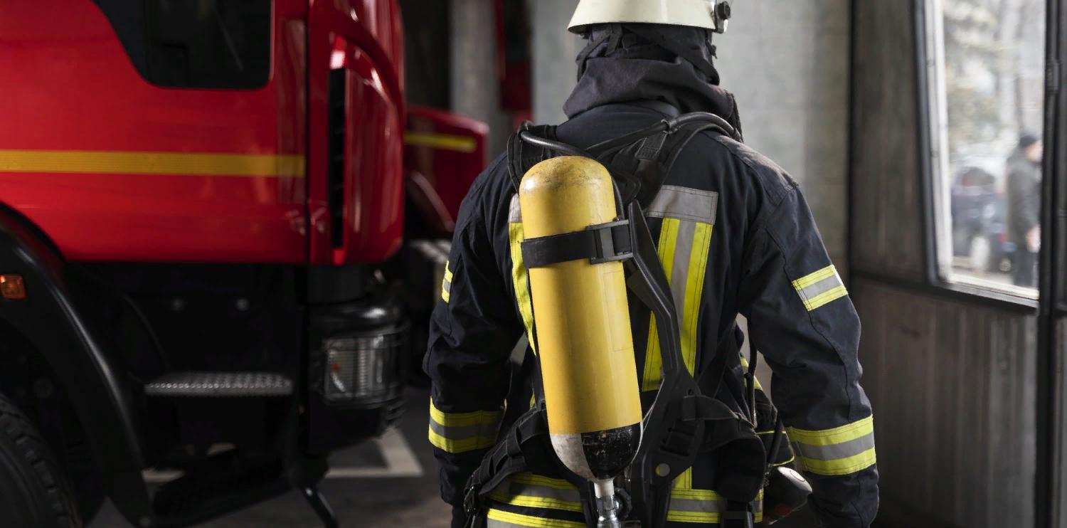 firefighter-at-the-station-with-suit-and-safety-helmet.jpg