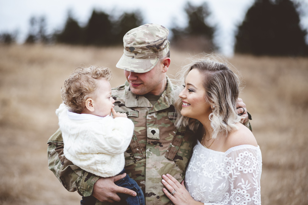 young-family-portrait-a-soldier-father-holding-his-son-and-a-beautiful-young-wife.jpg